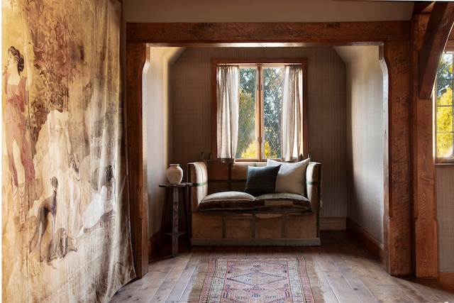 sitting room featuring beamed ceiling and light wood-type flooring