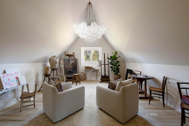 living room with light wood-type flooring, an inviting chandelier, and lofted ceiling