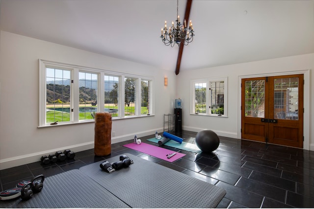 exercise room with dark tile patterned flooring, lofted ceiling, french doors, and a chandelier