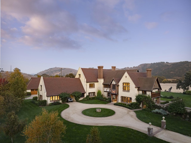 5200 Armour Ranch Rd, Santa Ynez, CA 93460 - view of front facade featuring a balcony, curved driveway, a chimney, a front yard, and a mountain view