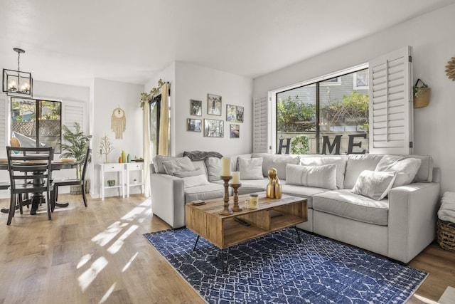 living room with a chandelier and wood-type flooring