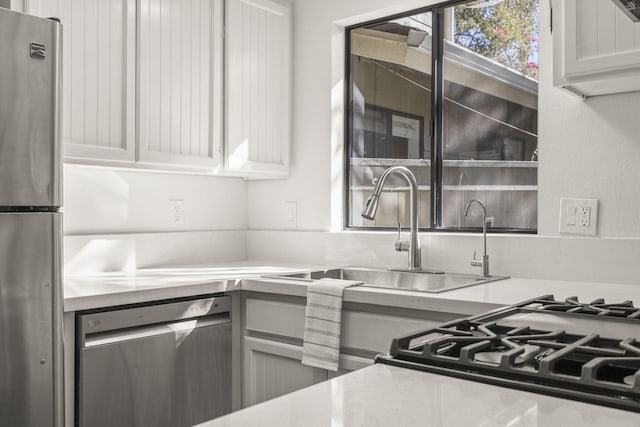 kitchen featuring white cabinetry, sink, and appliances with stainless steel finishes