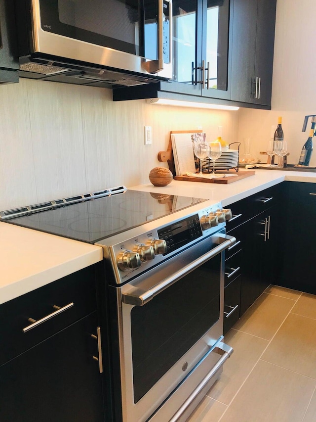 kitchen featuring light tile patterned floors and stainless steel appliances