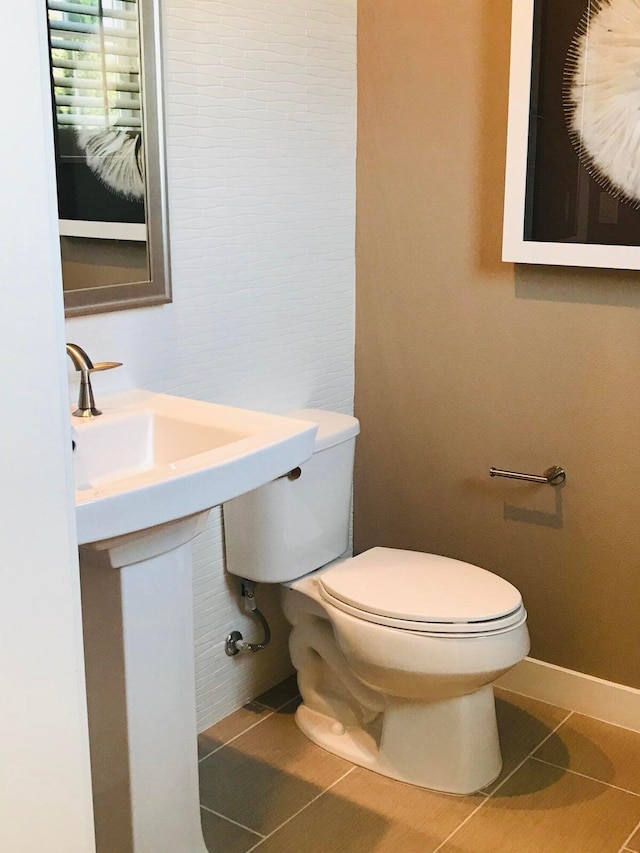 bathroom featuring tile patterned flooring and toilet