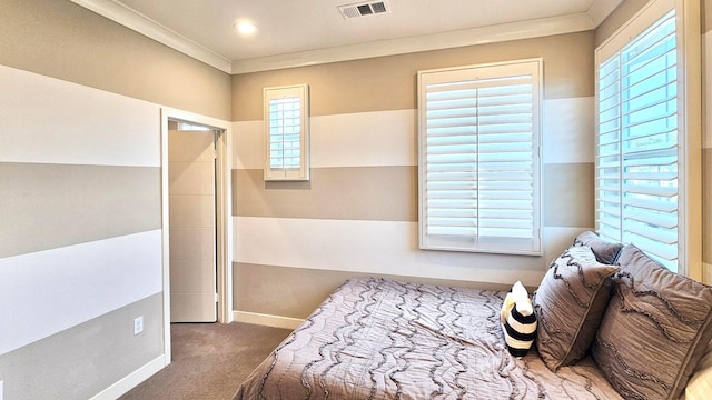 carpeted bedroom featuring multiple windows and ornamental molding