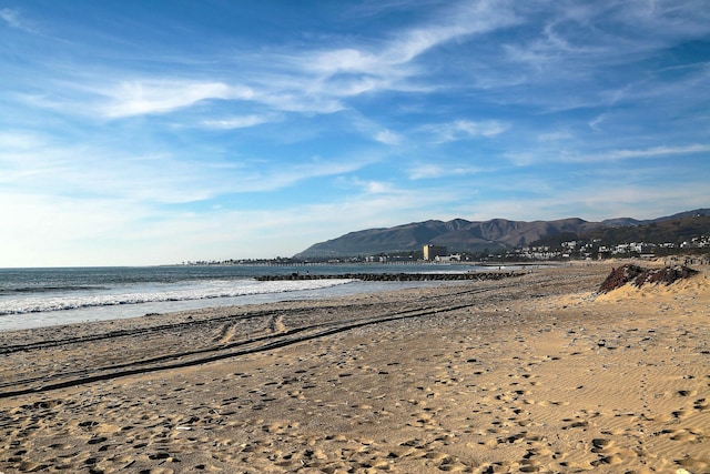 view of water feature featuring a mountain view and a beach view