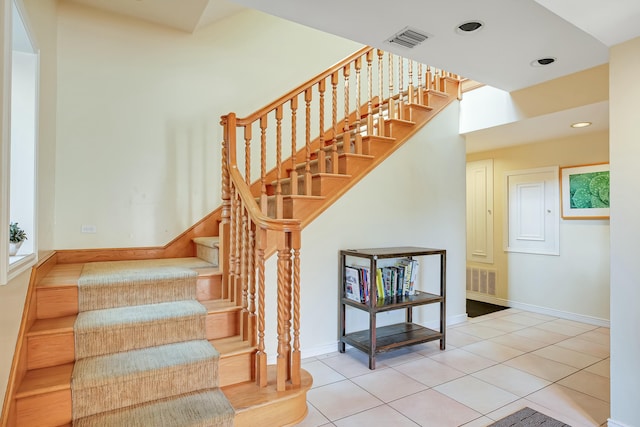 staircase with tile patterned floors