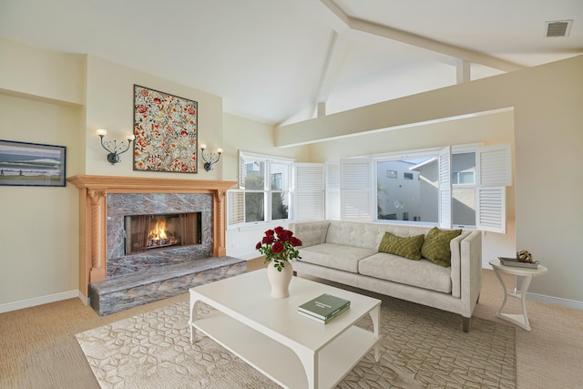 living room featuring light carpet, high vaulted ceiling, a fireplace, and beamed ceiling