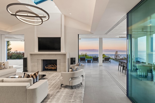 living room with a premium fireplace and a chandelier