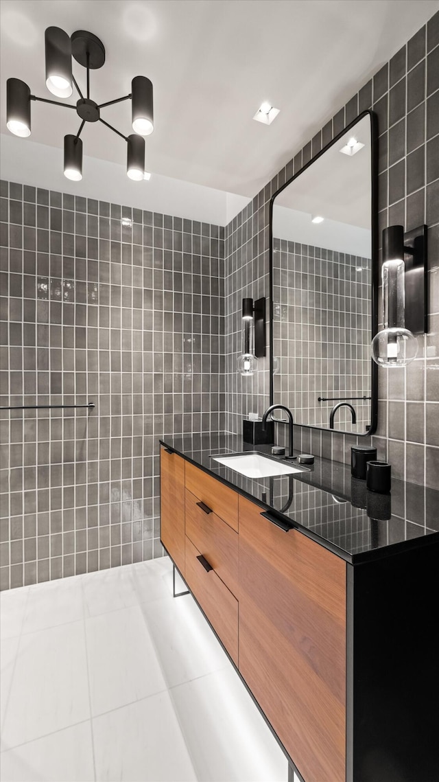 bathroom with vanity, tile patterned floors, and tile walls