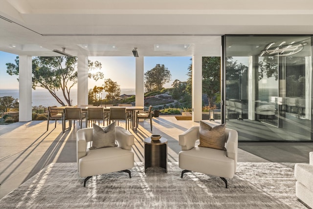 patio terrace at dusk featuring a water view