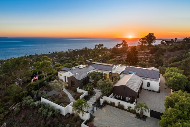 aerial view at dusk with a water view