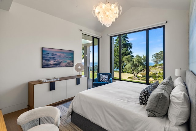 bedroom featuring a chandelier, hardwood / wood-style floors, and vaulted ceiling