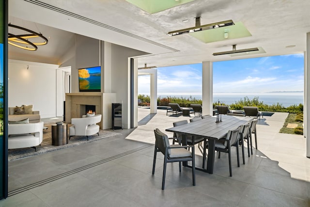 dining area featuring lofted ceiling and an outdoor fireplace