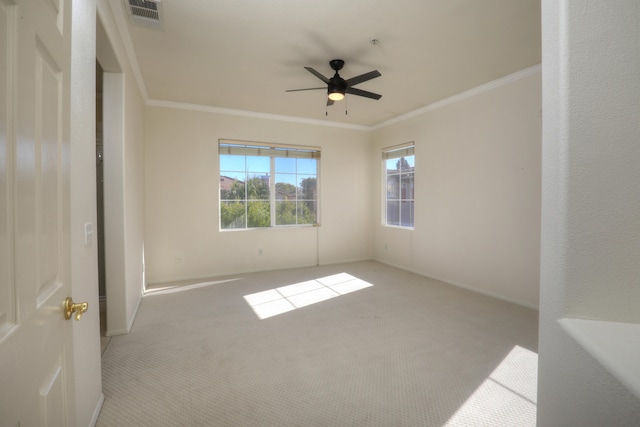 unfurnished room with ceiling fan, ornamental molding, and light carpet