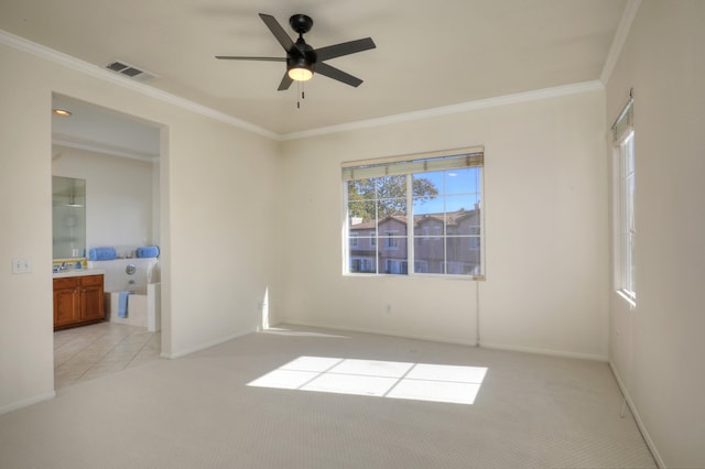 carpeted spare room featuring ceiling fan and crown molding