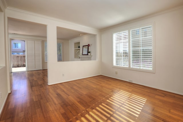 unfurnished room featuring hardwood / wood-style flooring and crown molding