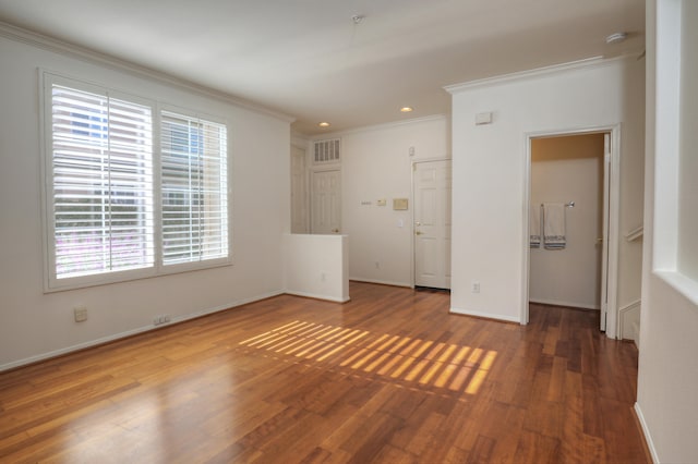 unfurnished bedroom featuring dark hardwood / wood-style floors and crown molding