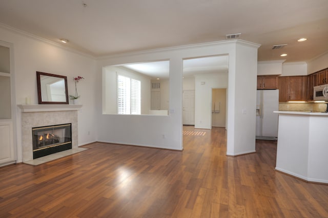 unfurnished living room with a high end fireplace, dark hardwood / wood-style floors, and ornamental molding