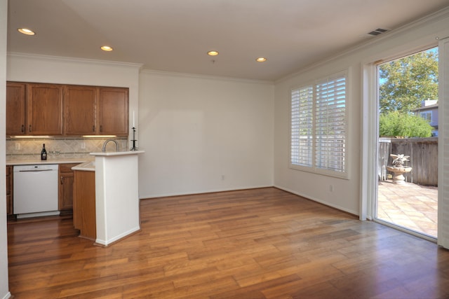 kitchen with dishwasher, ornamental molding, and light wood-type flooring