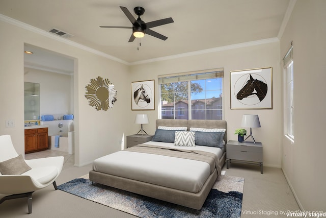 bedroom featuring ceiling fan, light colored carpet, ensuite bathroom, and crown molding