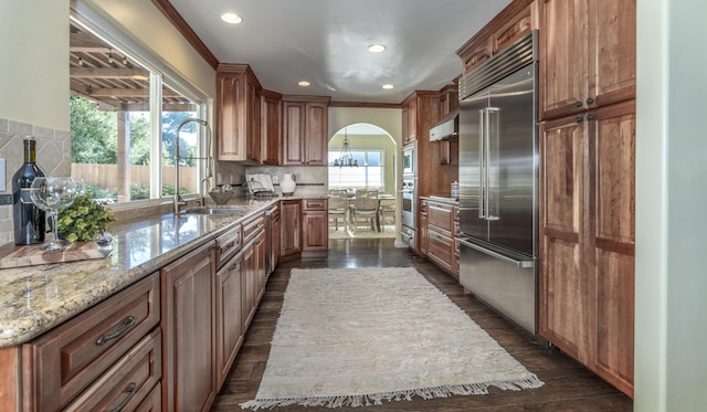 kitchen featuring plenty of natural light, a center island, backsplash, and appliances with stainless steel finishes