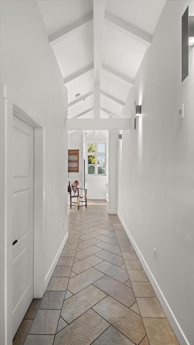 hallway with lofted ceiling with beams