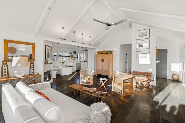 living room with beamed ceiling, dark hardwood / wood-style floors, and ceiling fan