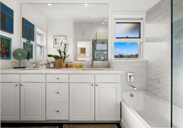 bathroom featuring plenty of natural light, separate shower and tub, and vanity