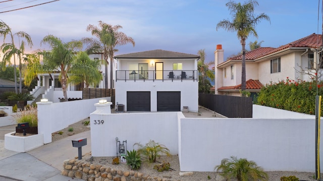 view of front of house featuring a balcony and a garage