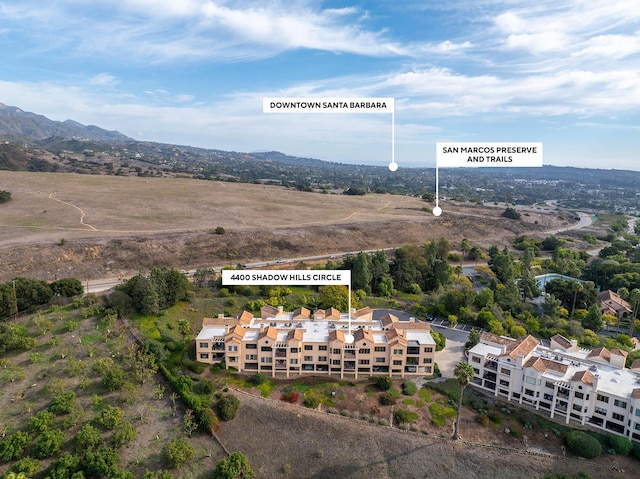 birds eye view of property with a mountain view