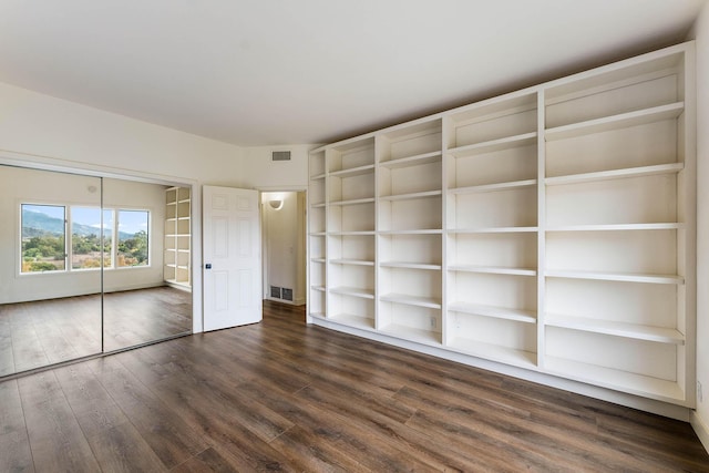 unfurnished bedroom featuring dark hardwood / wood-style floors