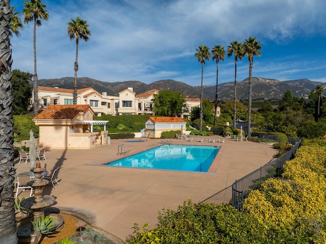 view of swimming pool featuring a mountain view and a patio