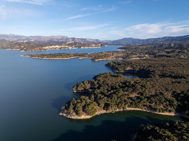 birds eye view of property featuring a water and mountain view