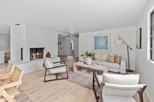 792 Chelham Way, Santa Barbara, CA 93108 - living area with a warm lit fireplace, arched walkways, and wood finished floors