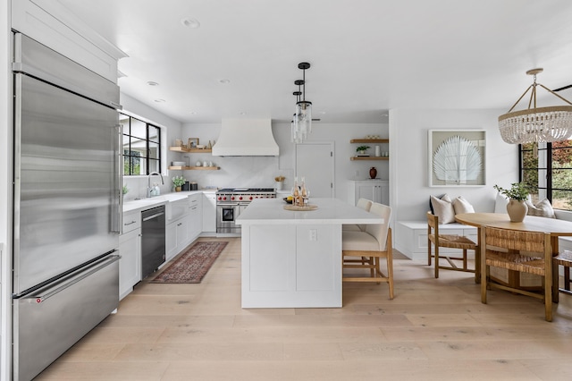 792 Chelham Way, Santa Barbara, CA 93108 - kitchen featuring premium appliances, premium range hood, open shelves, plenty of natural light, and recessed lighting