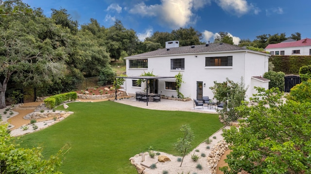 rear view of house featuring a lawn and a patio area