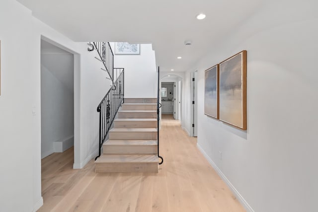 staircase with hardwood / wood-style floors