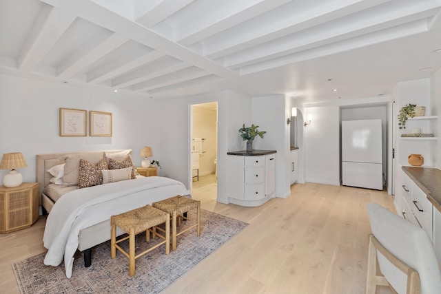 bedroom with beam ceiling, white refrigerator, ensuite bathroom, and light hardwood / wood-style floors