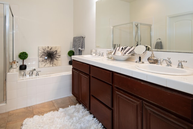 bathroom with tile patterned flooring, shower with separate bathtub, and vanity