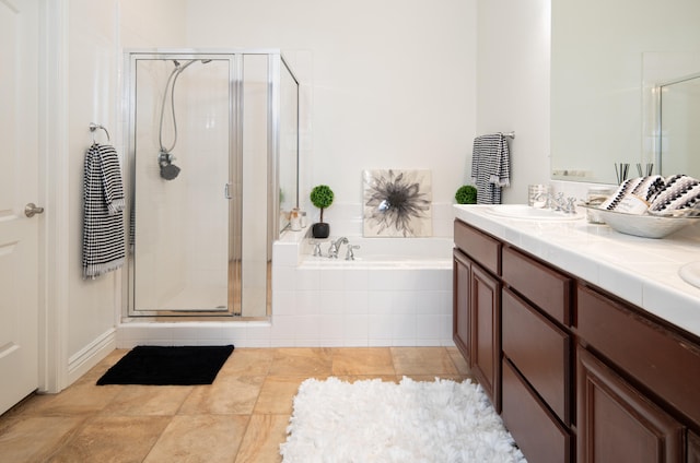 bathroom with vanity and separate shower and tub