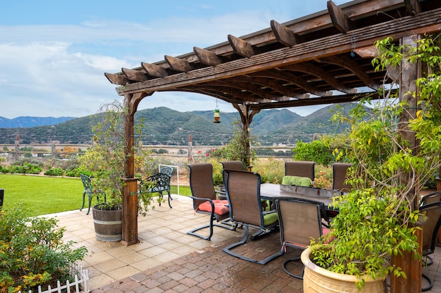 view of patio / terrace featuring a pergola and a mountain view