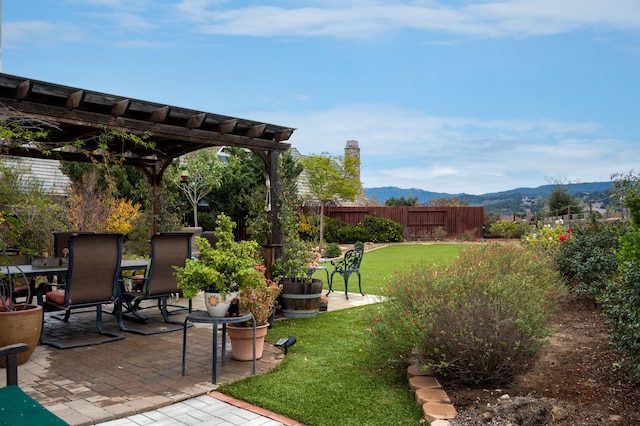 view of yard with a mountain view, a pergola, and a patio area