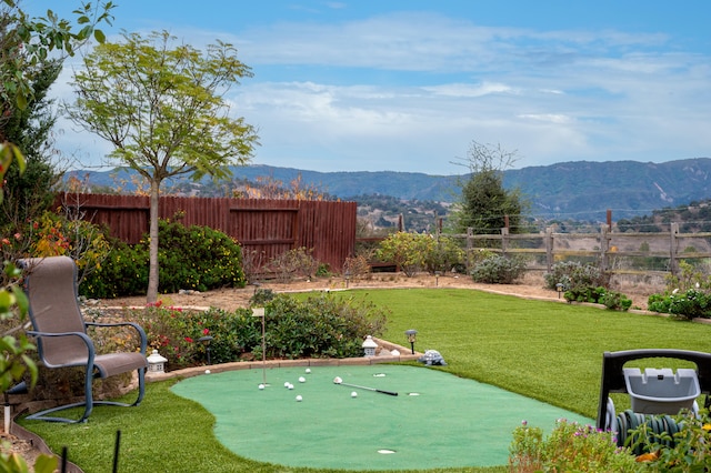 exterior space featuring a mountain view and a yard