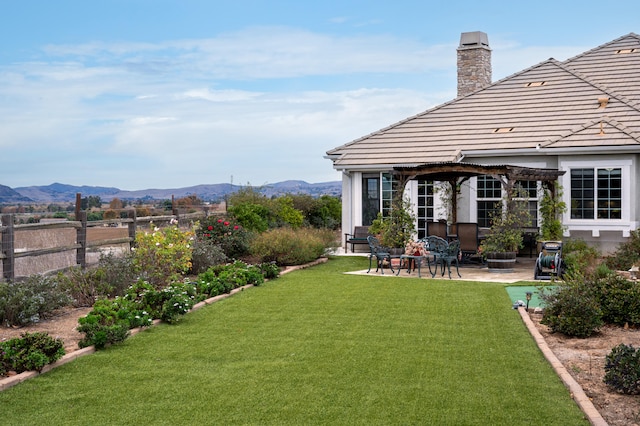 view of yard with a mountain view and a patio