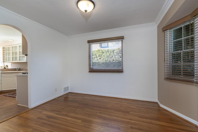 unfurnished room featuring dark hardwood / wood-style flooring and ornamental molding