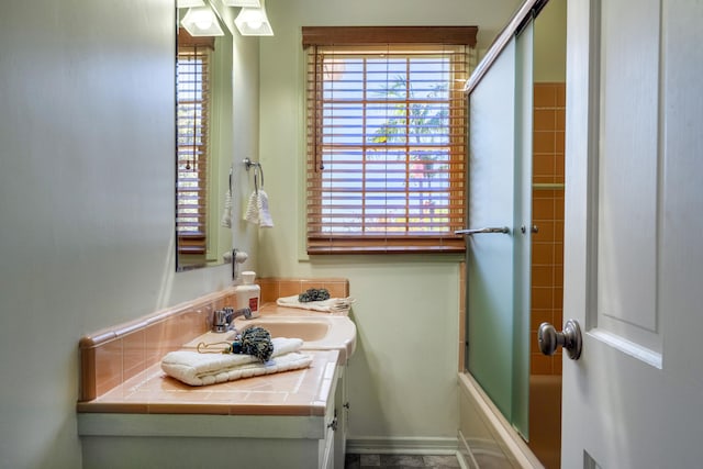 bathroom with vanity and enclosed tub / shower combo