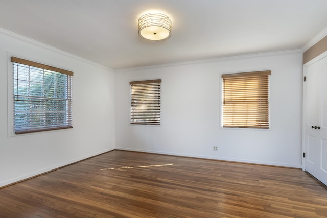 empty room featuring dark hardwood / wood-style floors and ornamental molding