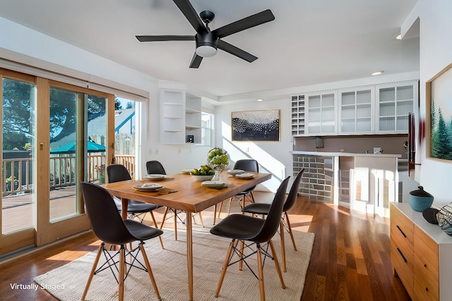 dining room with ceiling fan and dark wood-type flooring