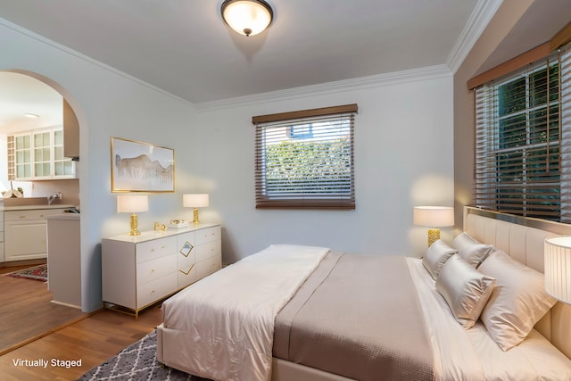 bedroom featuring light hardwood / wood-style flooring and ornamental molding